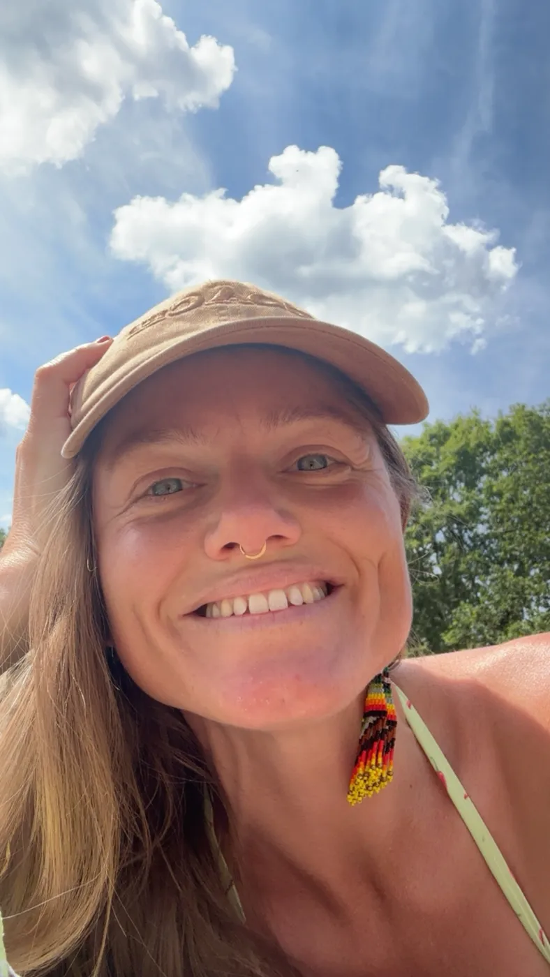Cassandra smiling under a blue sky